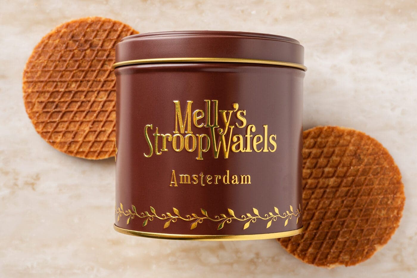 A classic Melly's stroopwafel next to a branded Amsterdam gift tin