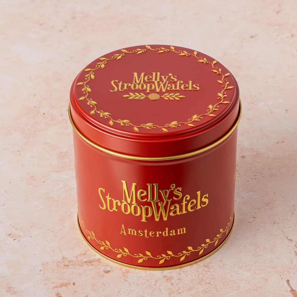 A red Melly's stroopwafel gift tin with gold lettering